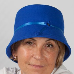 Front view headshot of a royal blue bucket wool felt hat with satinband and beaded design to front